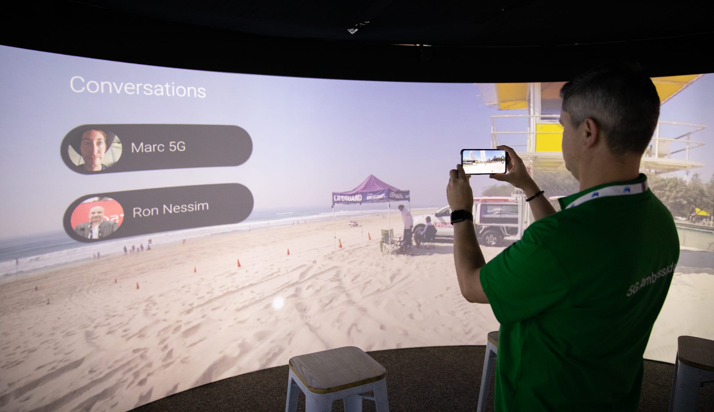 Man taking photo of Igloo immersive screen.