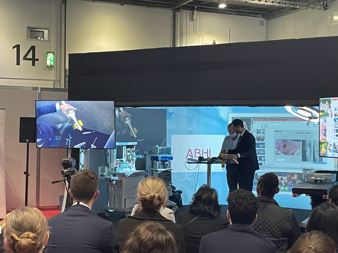 Raghbir demonstrating how a procedure is performed, with the BirdDog camera streaming live onto the wall of the cylinder behind them both.