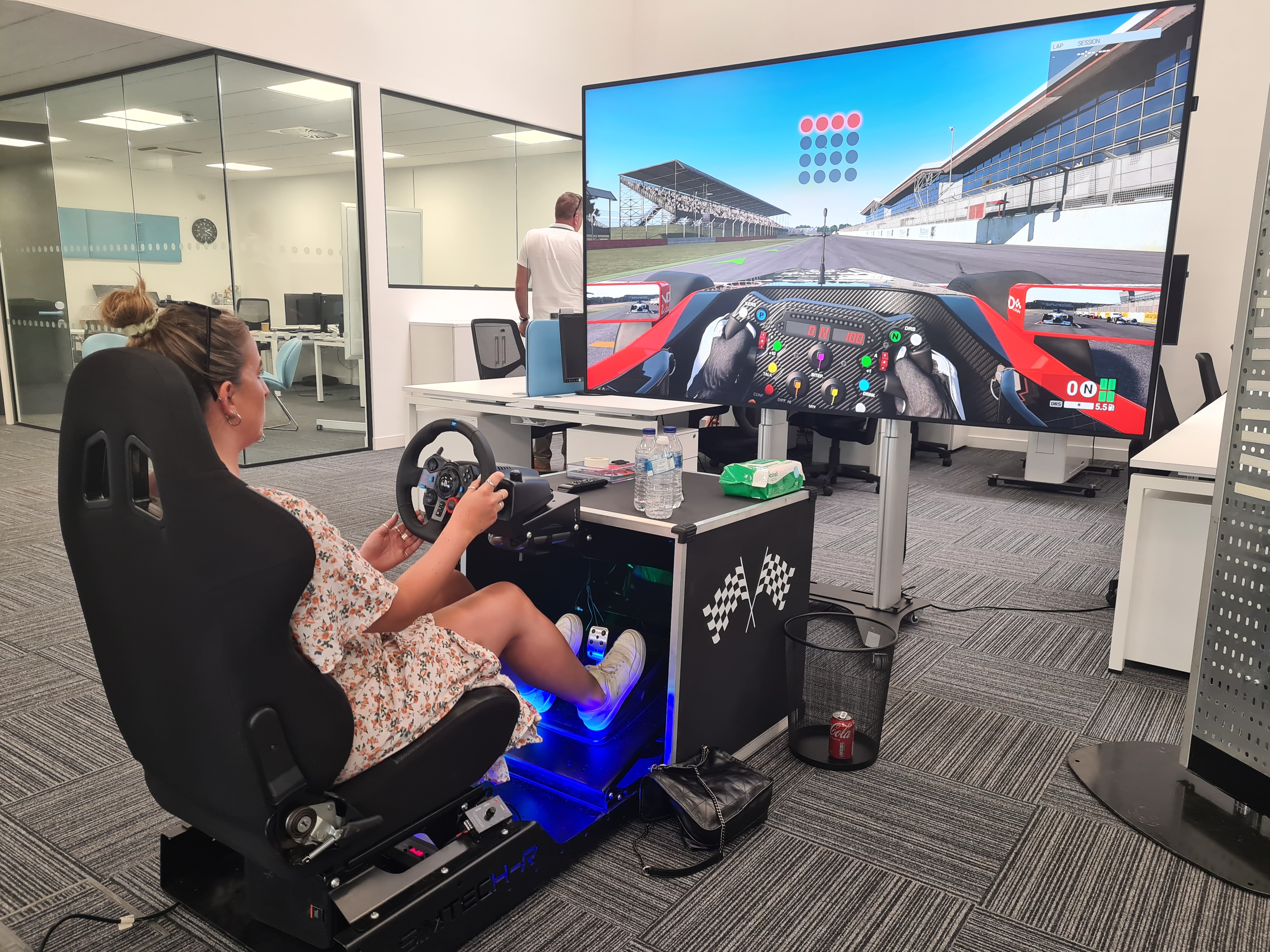 Woman playing immersive racing game.