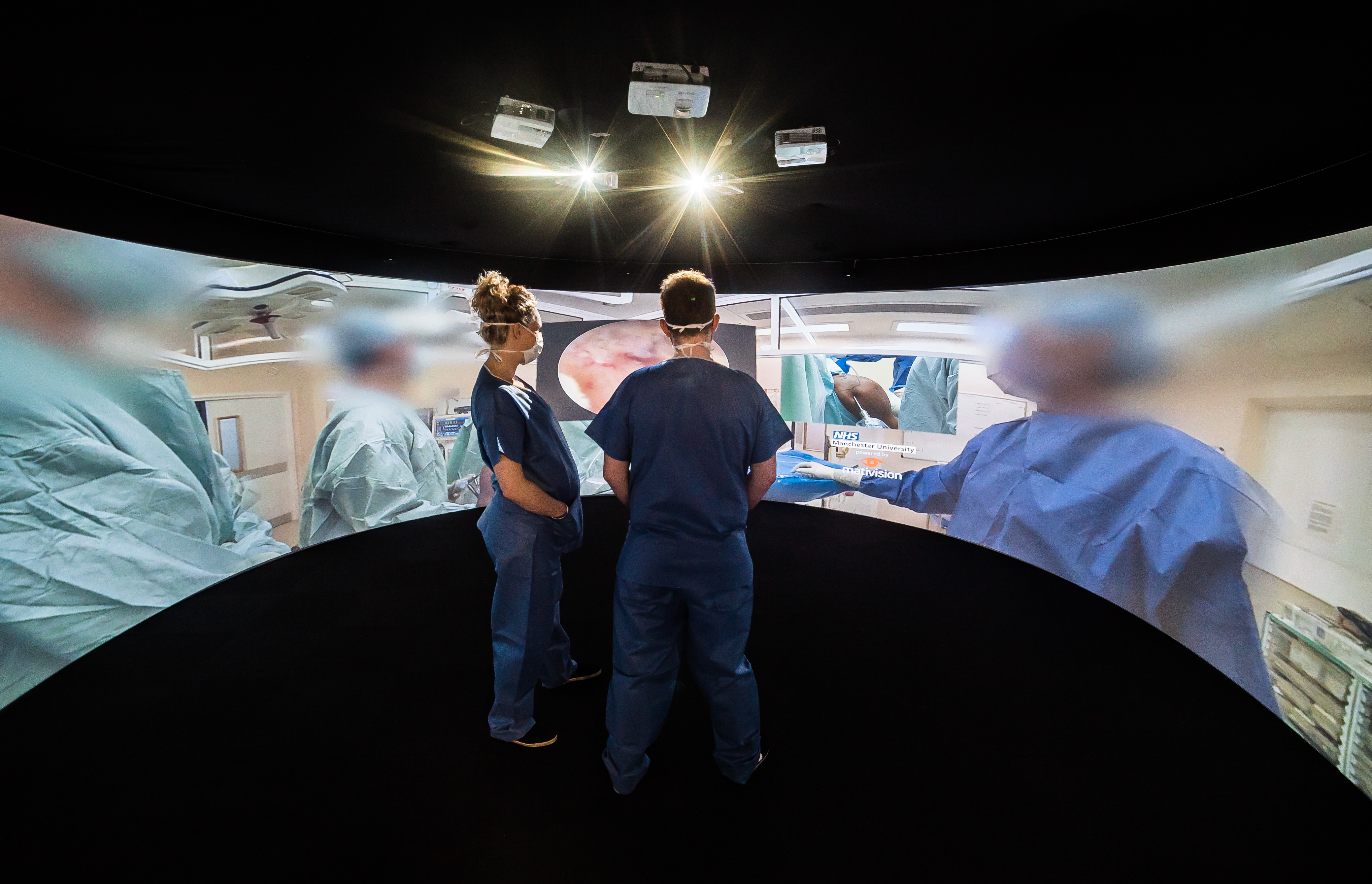 Medical students in scrubs learning with Igloo immersive technology