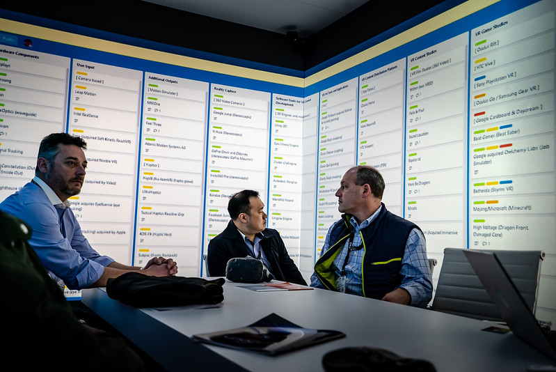 Three men using Igloo immersive space for their business meeting