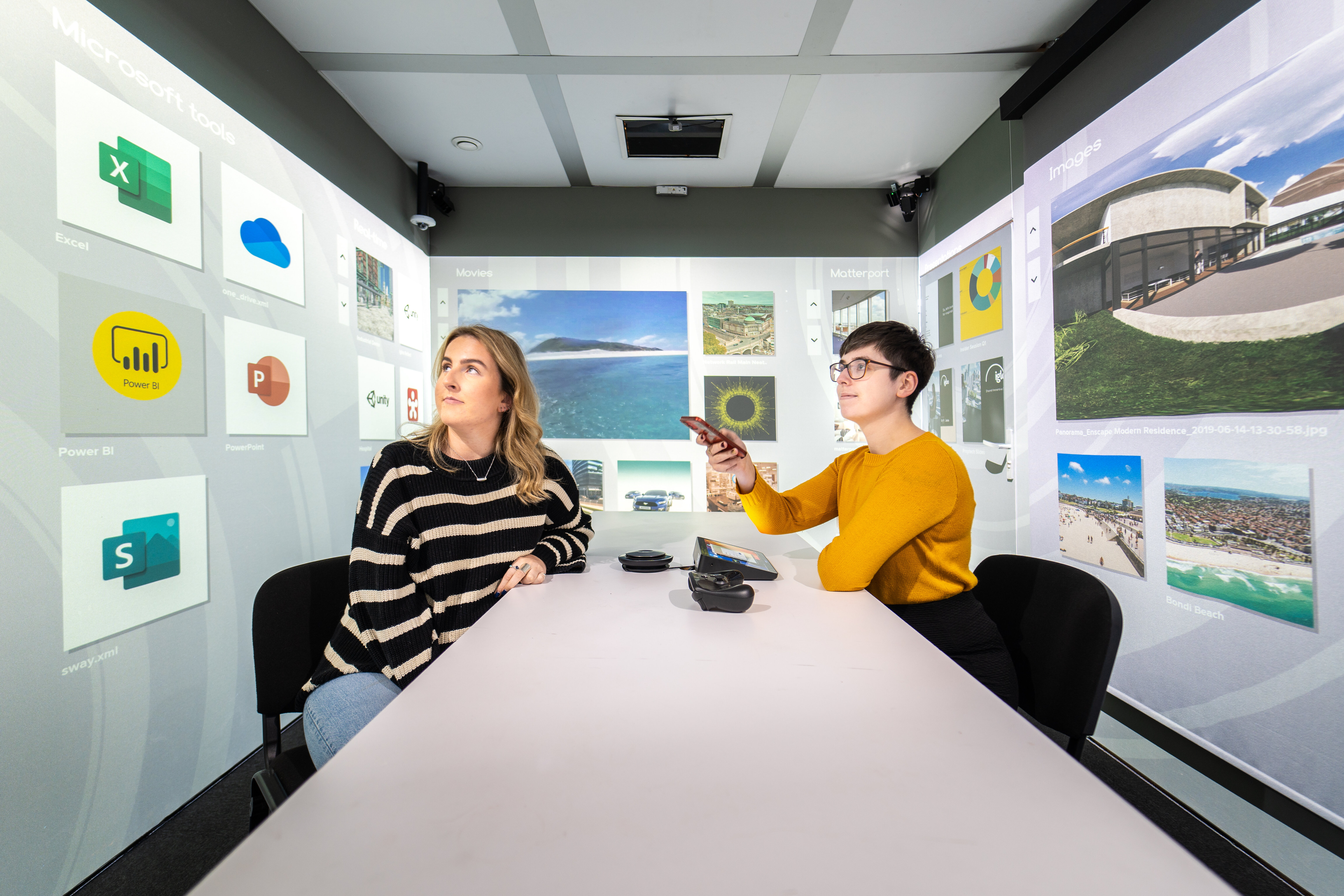Two women using Microsoft Windows tools in Igloo immersive meeting space
