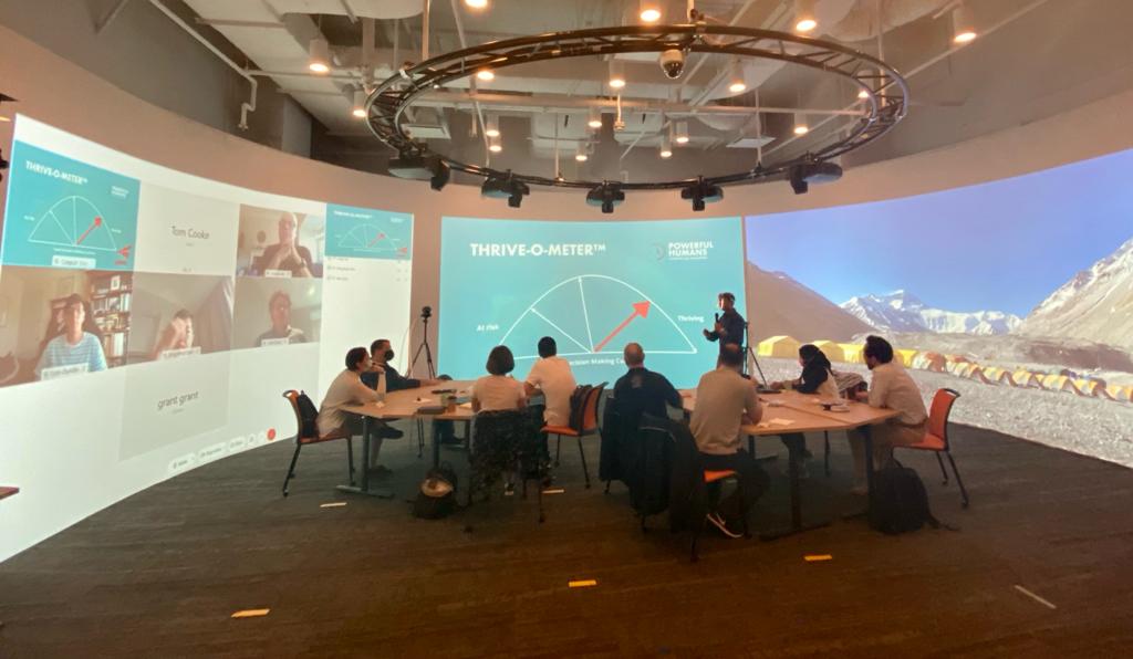 Man presenting to room of people for strategy meeting, using Igloo technology