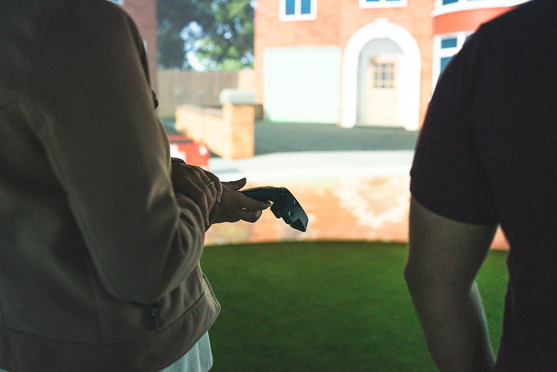 Two people looking at Igloo projection of a house.