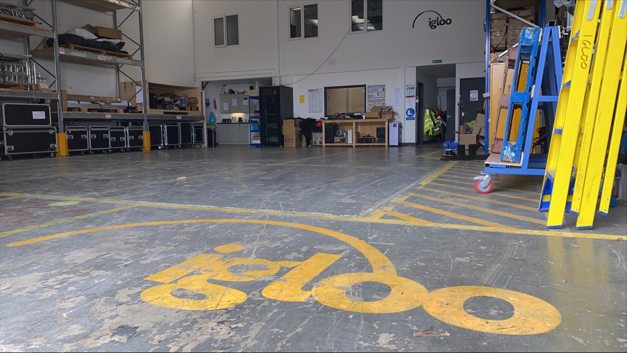 Igloo empty warehouse space with logo on floor.