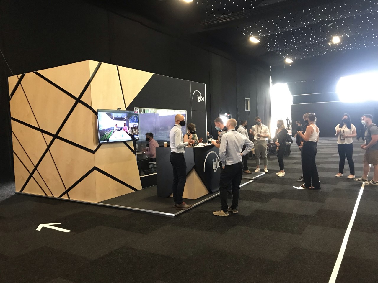 People using Igloo technology at a stand at Integrated Systems Europe (ISE London).