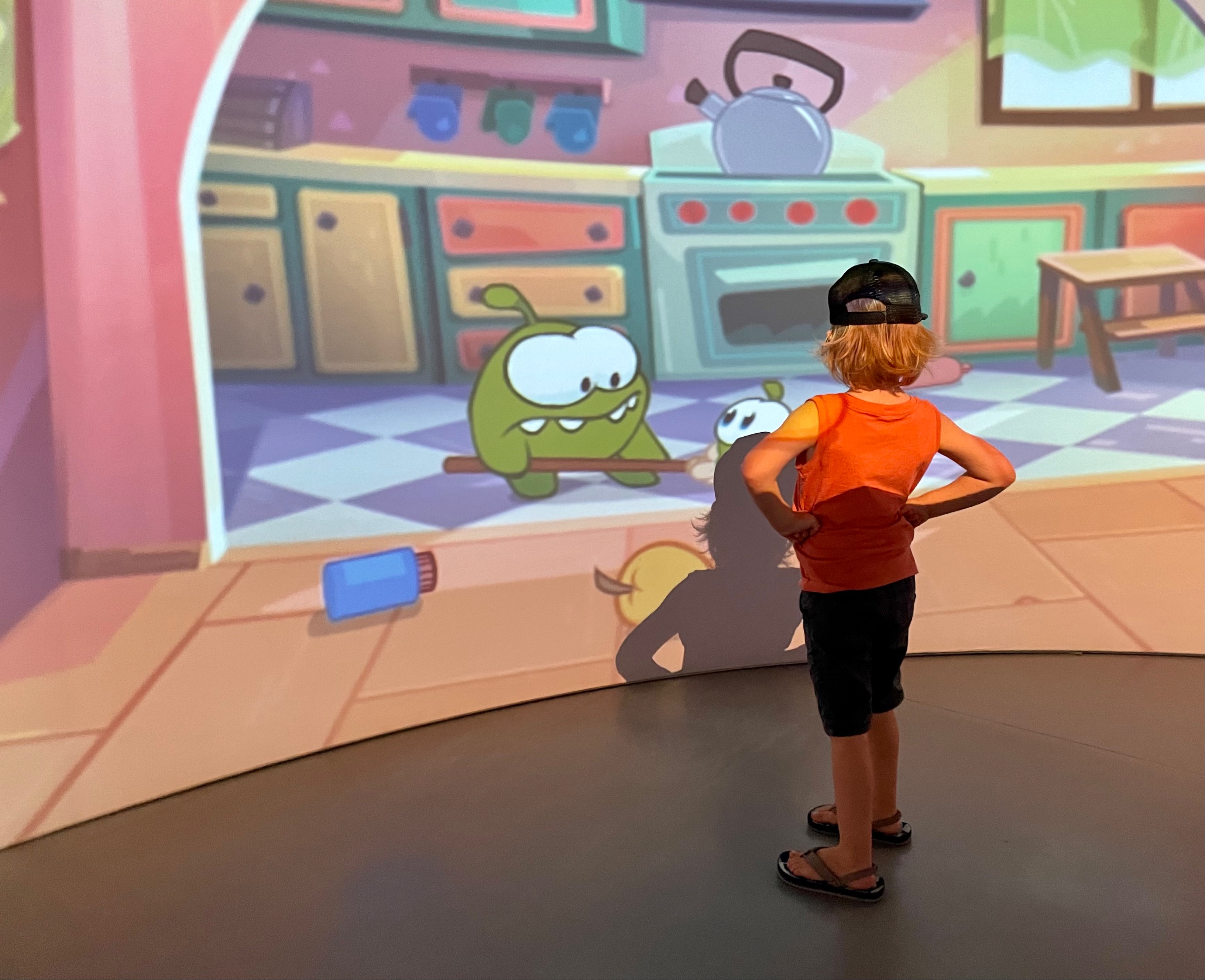 Child looking at large Igloo screen with cartoons on.