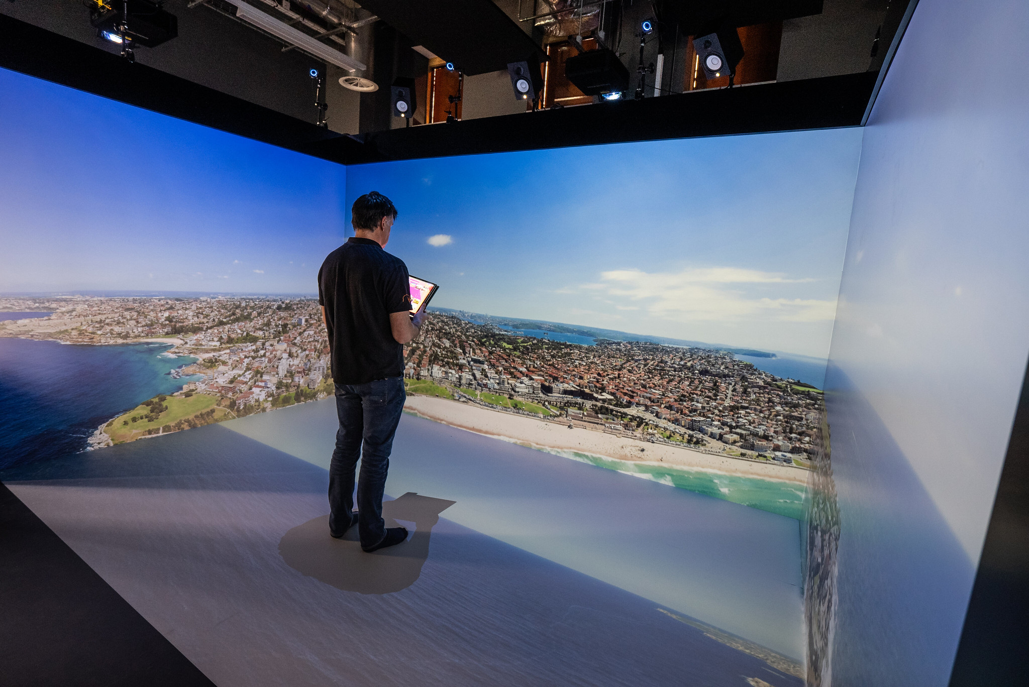 man in igloo cube with projection of island