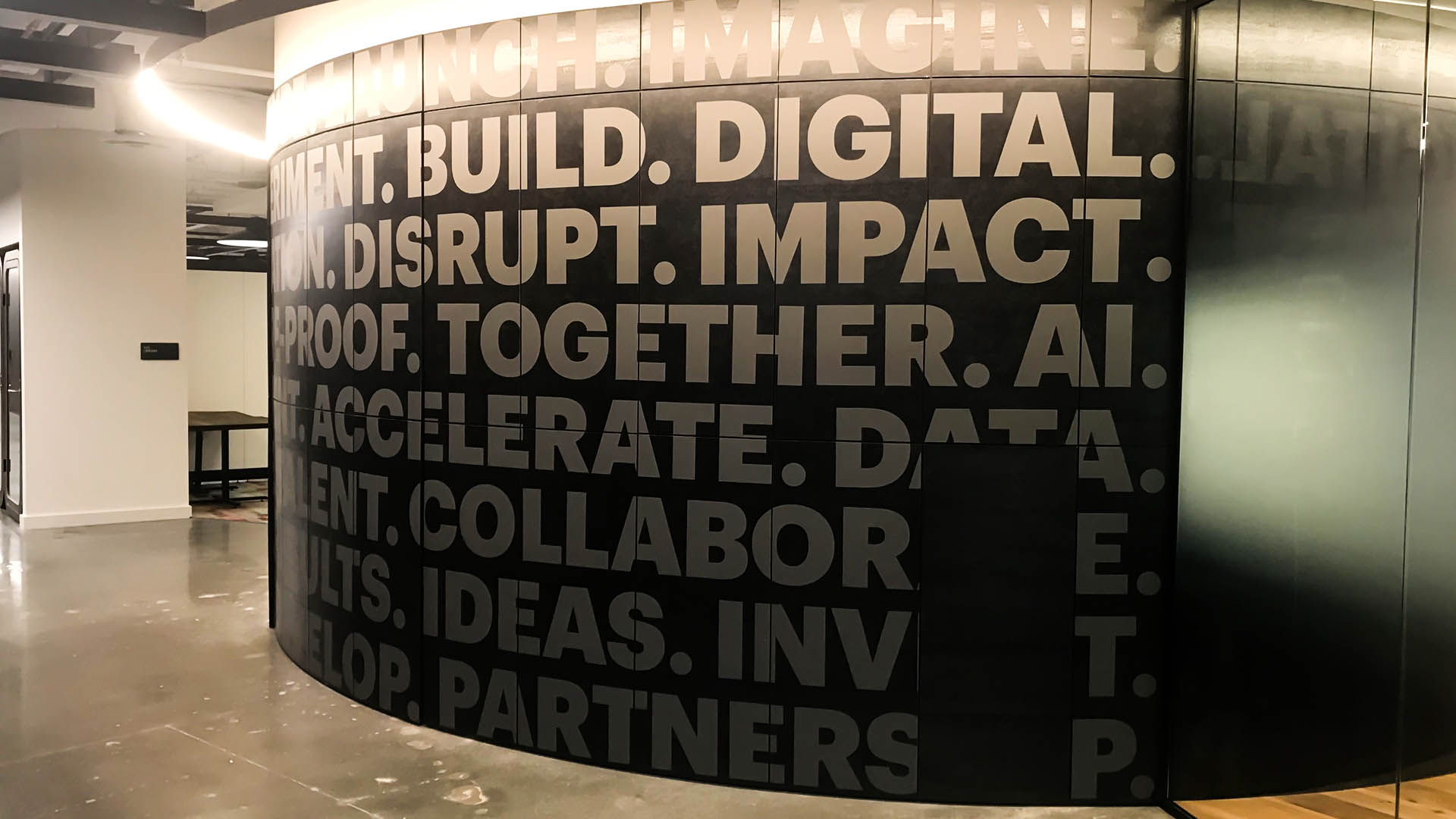 Black wall with digital, impact, proof, together written on.