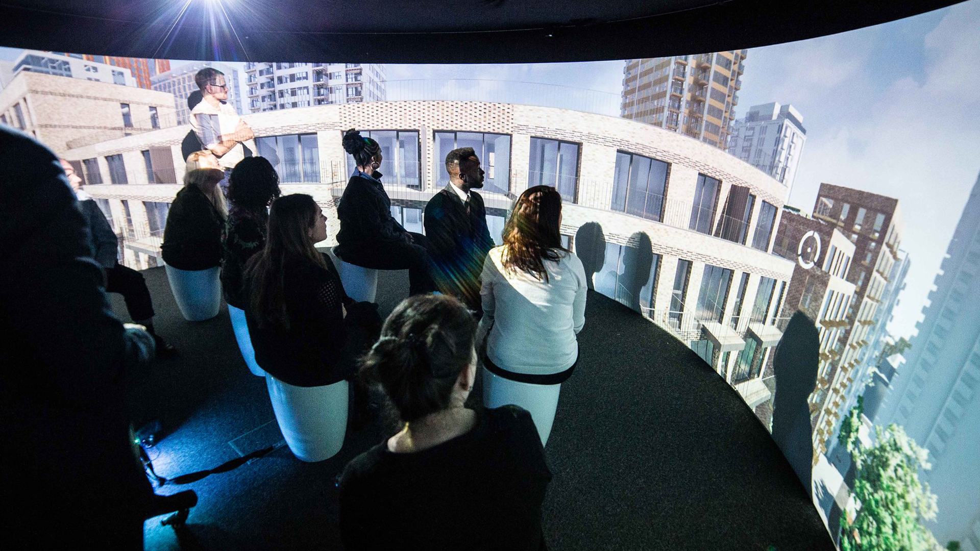 Large group of people looking at Igloo projection of apartments/high rises